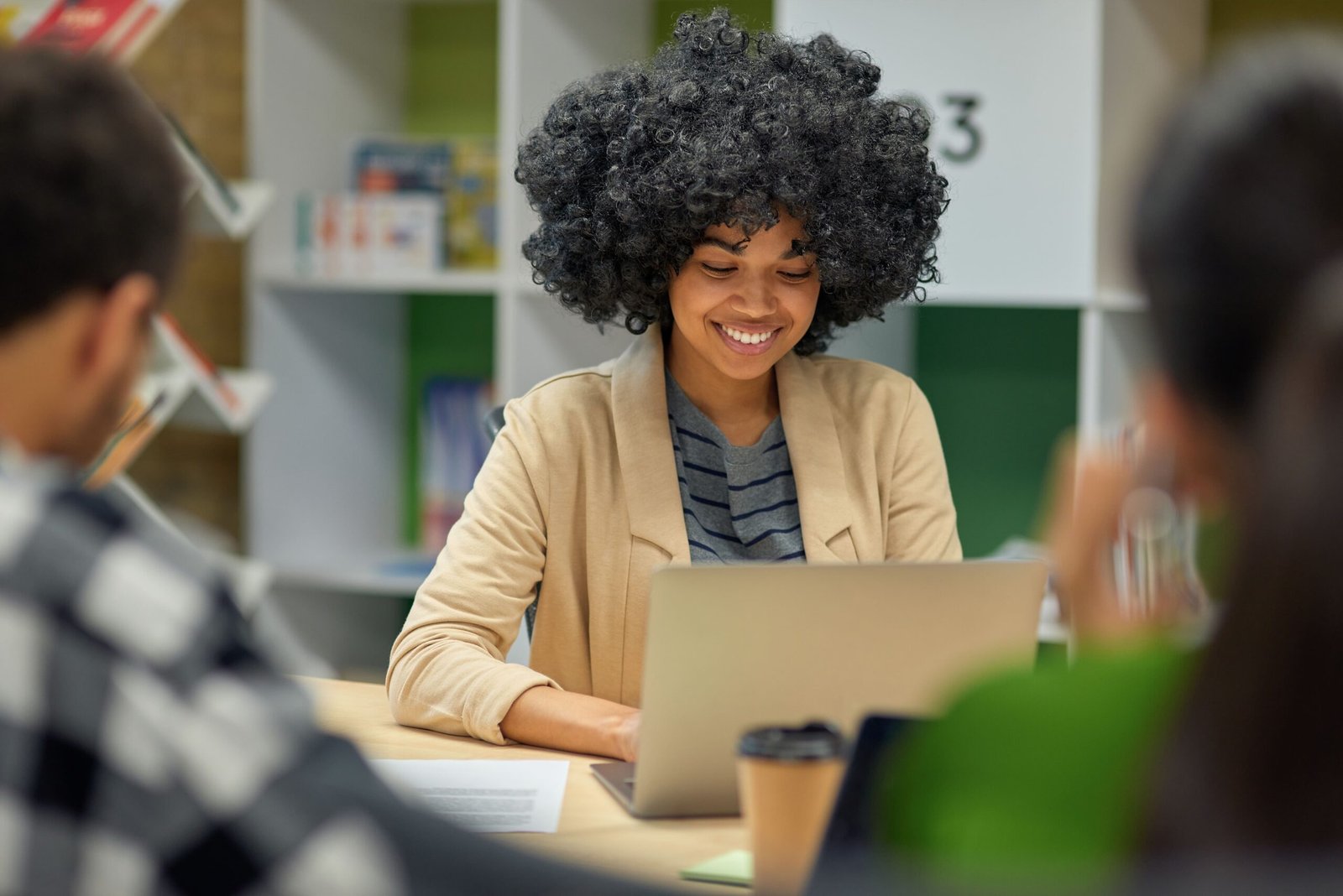 young-cheerful-mixed-race-woman-working-on-laptop-2026-01-09-08-07-51-utc